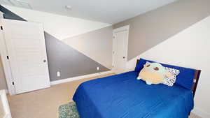 Bedroom featuring carpet flooring and baseboards