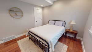 Bedroom featuring wood finished floors and recessed lighting