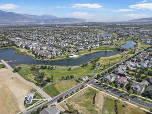 Aerial view of property and surrounding area with nearby suburban area and a water and mountain view