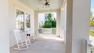 Covered porch featuring ceiling fan