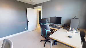 Office area with light carpet and baseboards