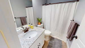 Bathroom featuring light wood-type flooring, vanity, and a shower with shower curtain