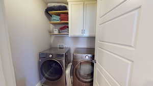 Laundry room with washing machine and clothes dryer and cabinet space