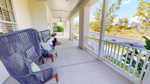 Covered porch featuring a ceiling fan