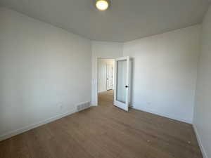 Spare room with wood finished floors and baseboards