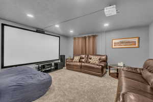 Home theater room with carpet and recessed lighting