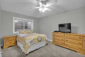 Bedroom with light carpet and a ceiling fan