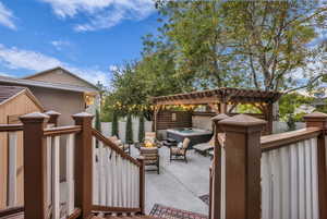Fenced backyard featuring an outdoor fire pit, a patio area, and a pergola