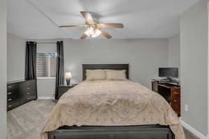 Bedroom featuring light carpet and a ceiling fan