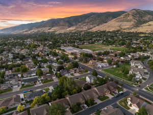 Aerial overview of property's location featuring a mountain backdrop and nearby suburban area