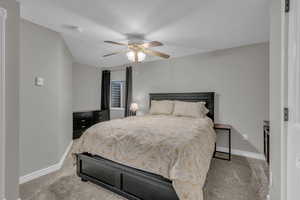 Bedroom featuring light colored carpet and ceiling fan