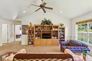 Living area with lofted ceiling, light colored carpet, a ceiling fan, and recessed lighting