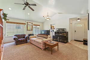 Living area featuring light carpet, a chandelier, a ceiling fan, and recessed lighting.