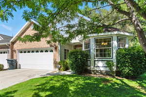 Twin home Style featuring a Garden Bay-Box Window, garage, and additional parking.