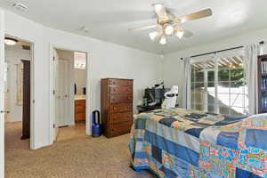 Carpeted bedroom featuring a ceiling fan and access to exterior