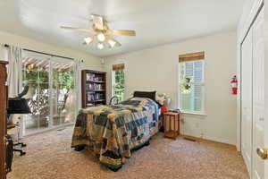 Bedroom featuring light colored carpet, a closet, access to outside, and a ceiling fan