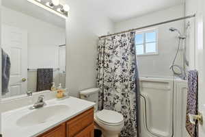 Full bath featuring vanity and shower / tub combo with curtain