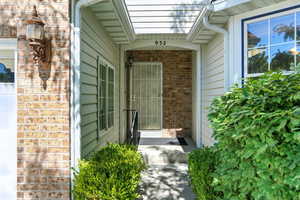 View of exterior entry with brick siding