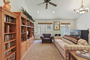 Living room with lofted ceiling, light carpet, recessed lighting, and a ceiling fan