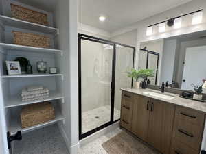 Full bath with a stall shower, vanity, light tile patterned floors, and recessed lighting