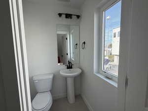 Bathroom with toilet and baseboards