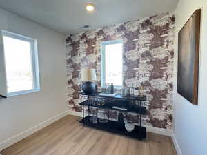 Detailed view of wood finished floors and wallpapered walls