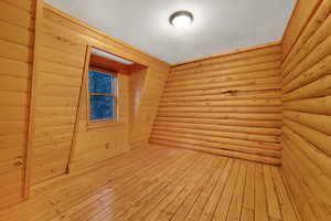 Empty room with hardwood / wood-style flooring and a sauna