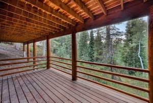 Deck featuring a wooded view