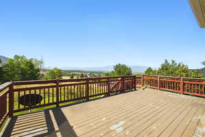 Wooden terrace featuring a mountain view