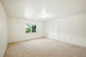 Empty room featuring carpet flooring