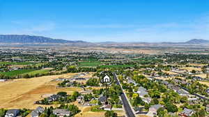 Aerial view of property's location with mountains and nearby suburban area