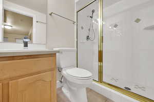 Bathroom with a stall shower, vanity, and tile patterned floors