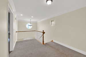 Carpeted spare room with ornamental molding and recessed lighting
