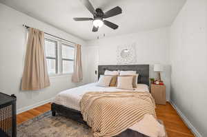 Bedroom with wood finished floors and ceiling fan