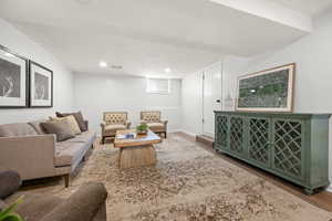 Living area with a textured ceiling, wood finished floors, and recessed lighting