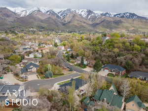 Aerial overview of property's location with a mountain backdrop and nearby suburban area