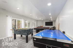 Living room with light carpet and recessed lighting