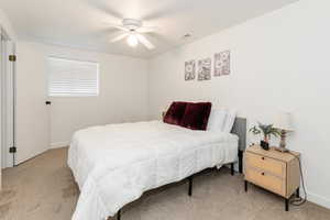 Bedroom with light carpet and ceiling fan