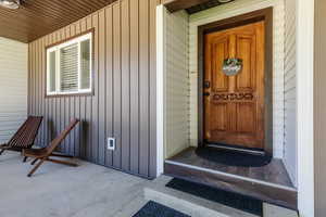 Doorway to property featuring board and batten siding