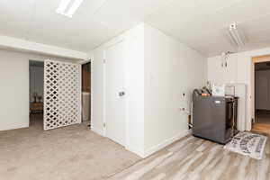 Finished below grade area featuring washer / clothes dryer and a paneled ceiling