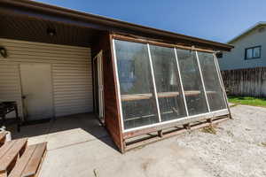 View of side of property with a sunroom
