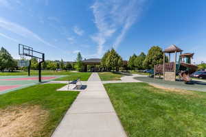 View of home's community featuring a yard, a patio, and community basketball court