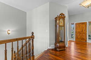 Entryway featuring dark wood finished floors and baseboards