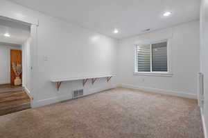 Spare room featuring light carpet and recessed lighting