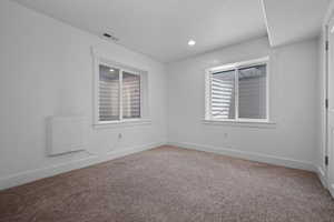 Spare room featuring carpet floors and recessed lighting