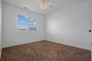 Spare room with carpet floors and ceiling fan
