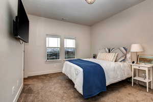 Bedroom featuring carpet floors and baseboards