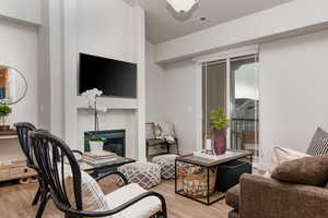 Living room with a tiled fireplace and light wood-style floors
