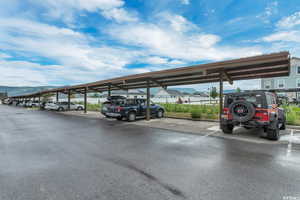 Covered parking lot featuring a mountain view