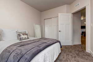 Bedroom with carpet floors and a closet